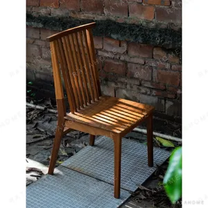 Burmese Teak Spindle-Back Dining Chair in clay — in a room setting