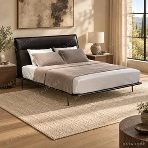 Black Leather Curved-Headboard Bed on Metal Legs in black — in a room setting