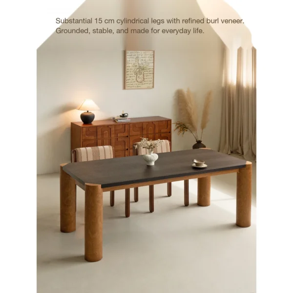 Bedrock Dining Table with Dark Top and Burl Cylinder Legs in black — in a room setting