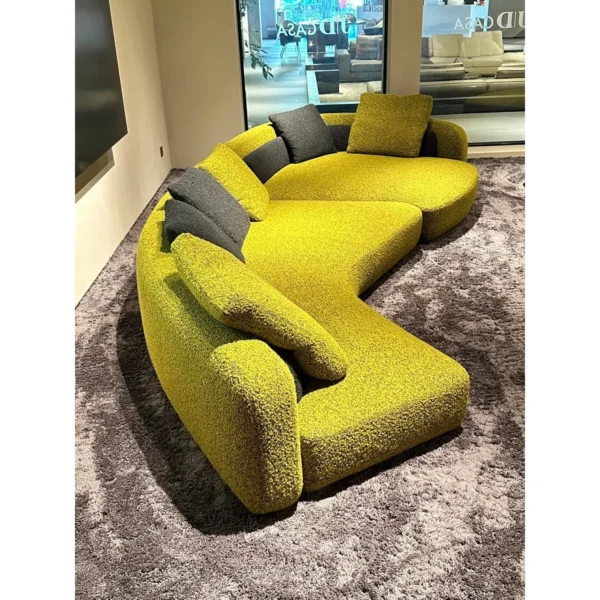 Bessel Curved Sectional Sofa in olive — in a room setting