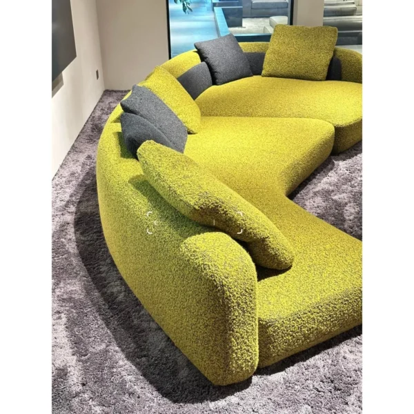 Bessel Curved Sectional Sofa in olive — in a room setting