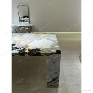 Black Diamond Pandora Stone Dining Table on Angled Slab Legs in black — in a room setting