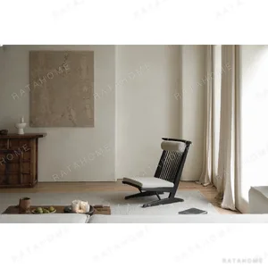 Black Spindle-Back Cantilever Lounge Chair with Wood Seat in black — in a room setting