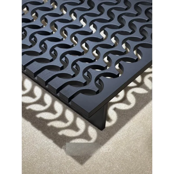 Black Solid Wood Coffee Table with Pierced Wave Top in black — in a room setting