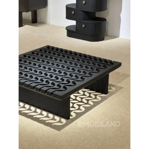 Black Solid Wood Coffee Table with Pierced Wave Top in black — in a room setting