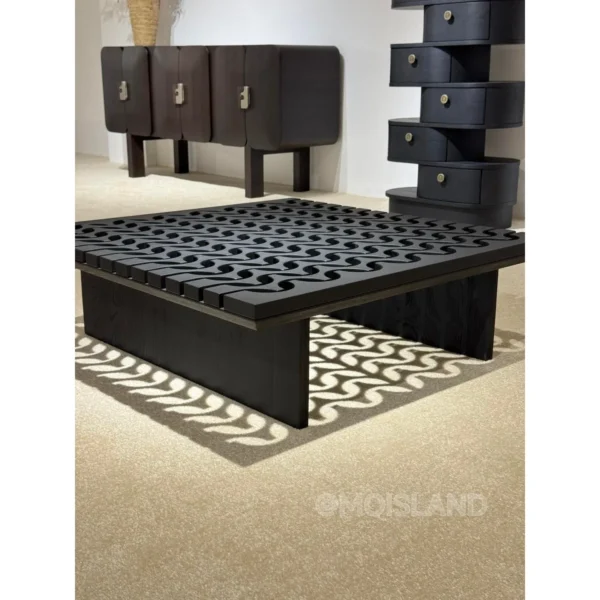 Black Solid Wood Coffee Table with Pierced Wave Top in black — in a room setting