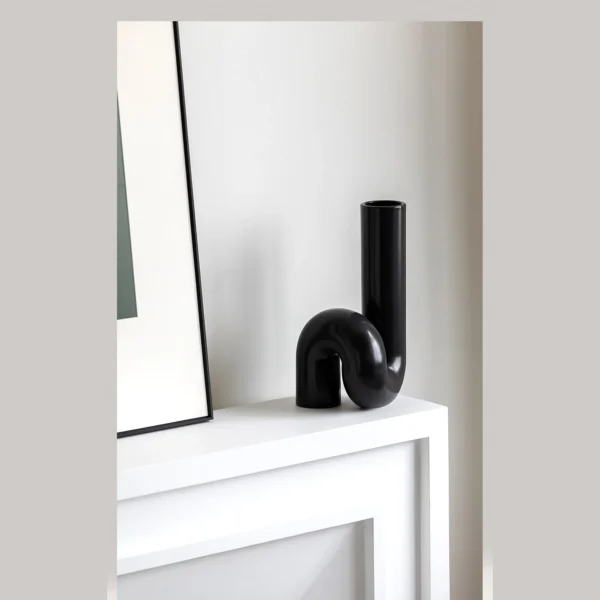 Black Twisted Tube Sculptural Ceramic Vase in black — in a room setting