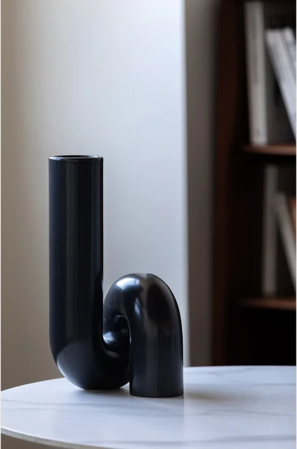 Black Twisted Tube Sculptural Ceramic Vase in black — in a room setting