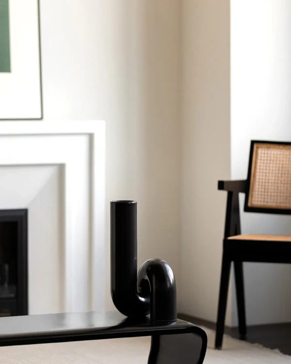 Black Twisted Tube Sculptural Ceramic Vase in black — in a room setting