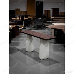 Black Walnut Long Table on Faceted Microcement Bases in walnut — in a room setting