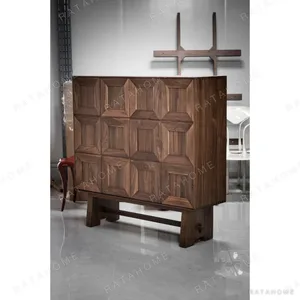 Black Walnut Faceted-Panel Cabinet on Trestle Base in walnut — in a room setting