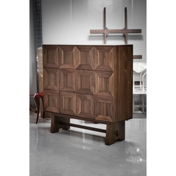 Black Walnut Faceted-Panel Cabinet on Trestle Base in walnut — in a room setting