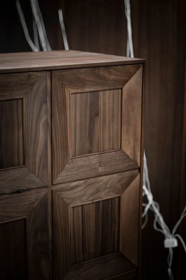 Black Walnut Faceted-Panel Cabinet on Trestle Base in walnut — detail