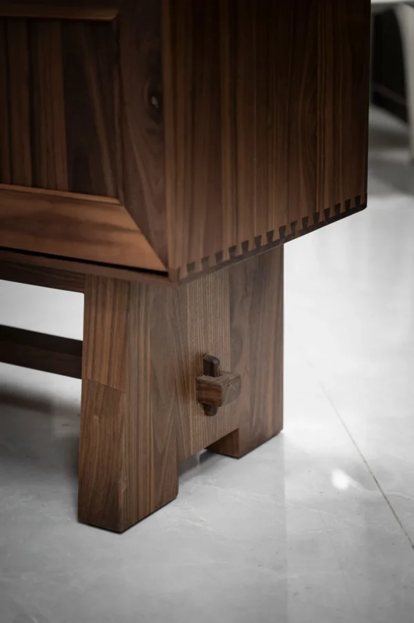 Black Walnut Faceted-Panel Cabinet on Trestle Base in walnut — detail