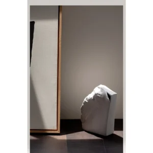 Black Rock Texture Ceramic Sculpture Vase in black — in a room setting