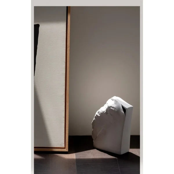 Black Rock Texture Ceramic Sculpture Vase in black — in a room setting