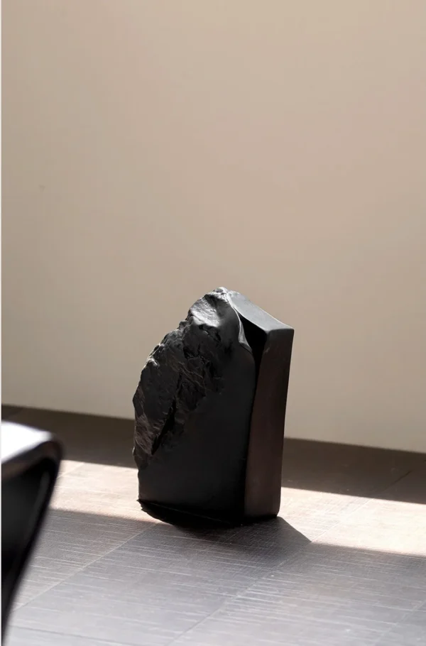 Black Rock Texture Ceramic Sculpture Vase in black — in a room setting