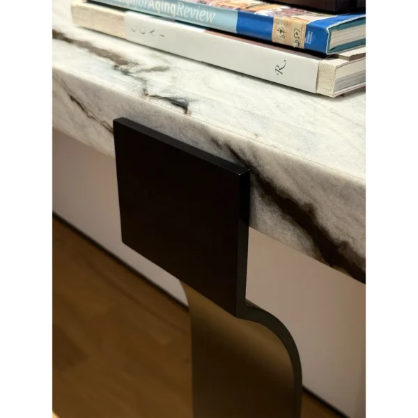 Arche Black-and-White Marble Console on Curved Metal Base in ivory — in a room setting