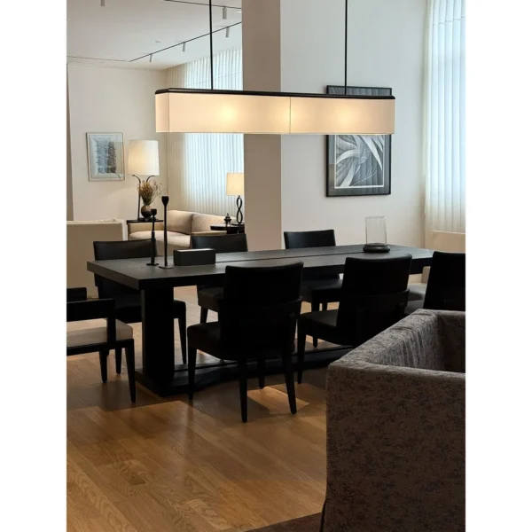 Black Oak Long Dining Table with Black and White Chairs in black — in a room setting