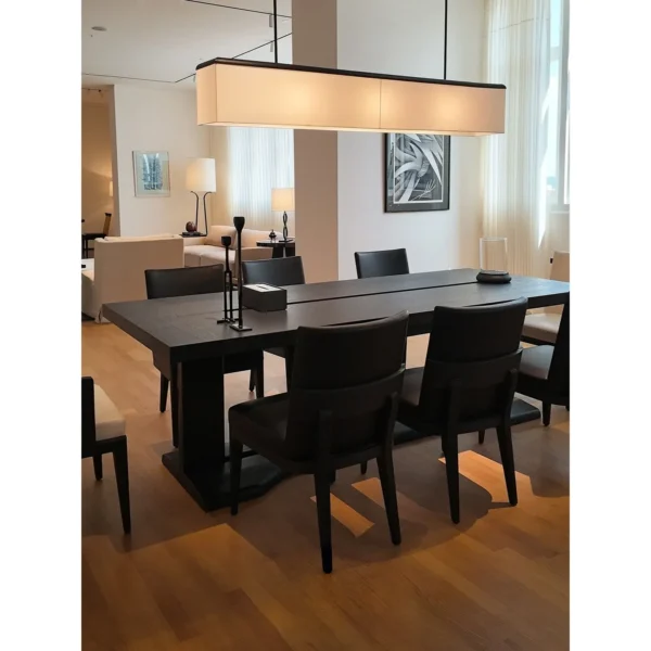 Black Oak Long Dining Table with Black and White Chairs in black — in a room setting