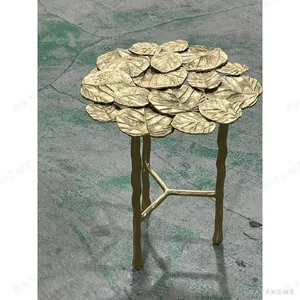 Brass Lily Pad Side Table on Branch Legs in brushed brass — in a room setting