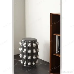 Brown and White Beaded Leather Drum Stool in clay — in a room setting