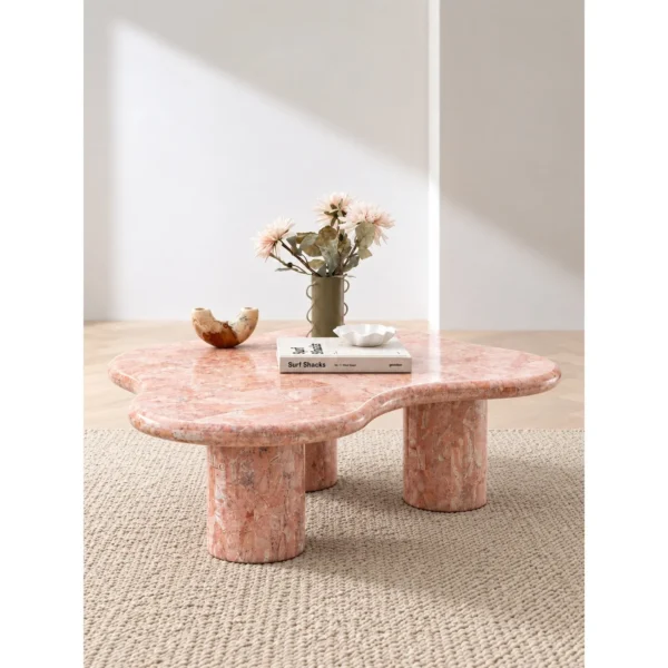 Pink Cloud Marble Coffee Table on Cylinder Legs in rose stone — in a room setting