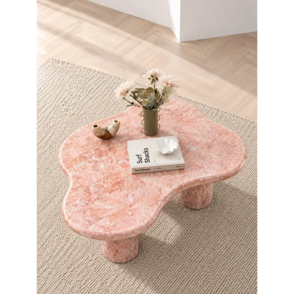 Pink Cloud Marble Coffee Table on Cylinder Legs in rose stone — in a room setting