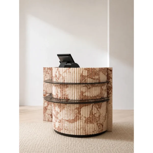 Pink Marble Curved Reception Desk with Black Metal Trim in rose stone — in a room setting