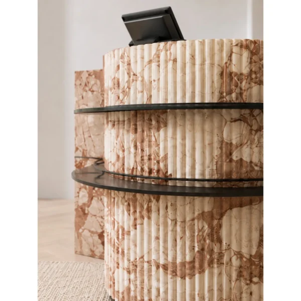 Pink Marble Curved Reception Desk with Black Metal Trim in rose stone — in a room setting