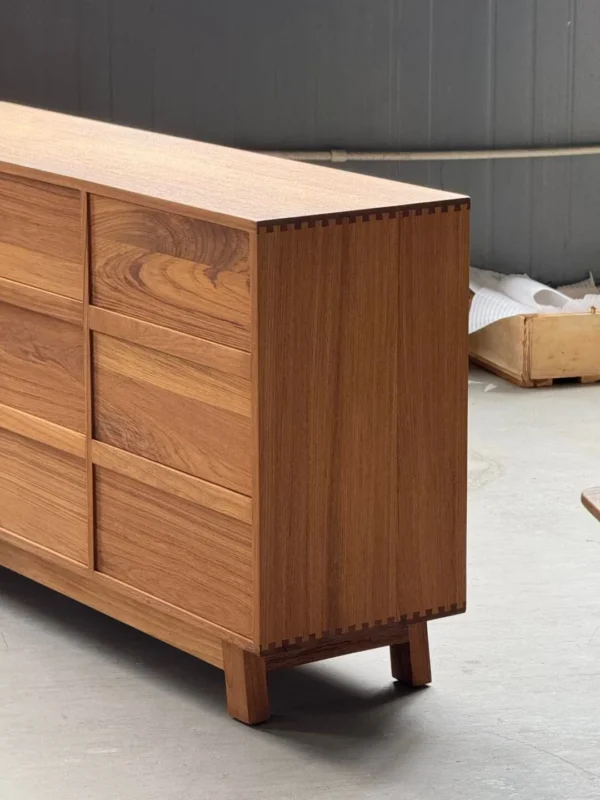 Burmese Teak Nine-Drawer Chest with Angled Fronts in clay — in a room setting