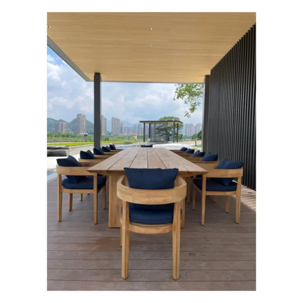 Burmese Teak Outdoor Long Table in natural oak — in a room setting