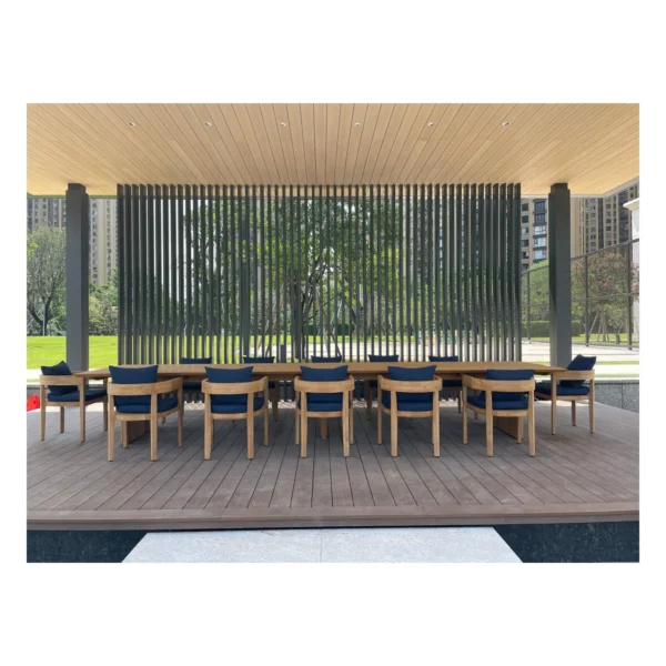 Burmese Teak Outdoor Long Table in natural oak — in a room setting