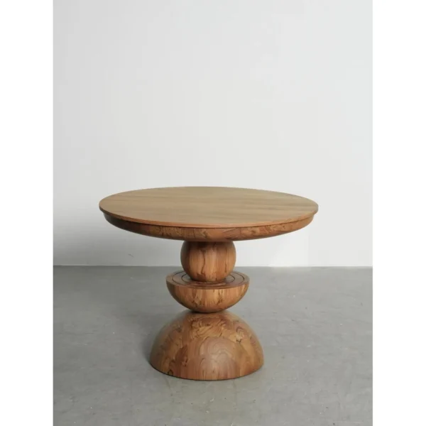 Burmese Teak Round Table on Stacked Sphere Base in natural oak — in a room setting