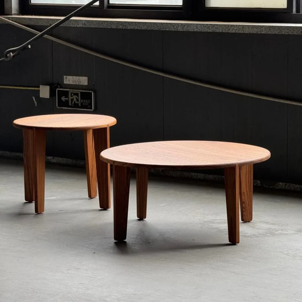 Burmese Teak Round Nesting Coffee Table Pair in clay — front view