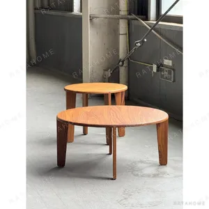 Burmese Teak Round Nesting Coffee Table Pair in clay — in a room setting