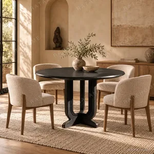 Cangshi Black Stone Round Table on U-Form Base in black — in a room setting