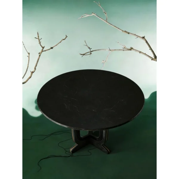 Cangshi Black Stone Round Table on U-Form Base in black — in a room setting
