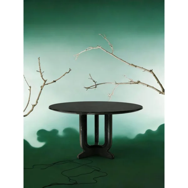 Cangshi Black Stone Round Table on U-Form Base in black — in a room setting