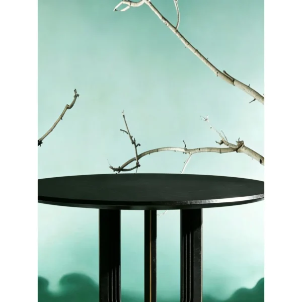 Cangshi Black Stone Round Table on U-Form Base in black — in a room setting