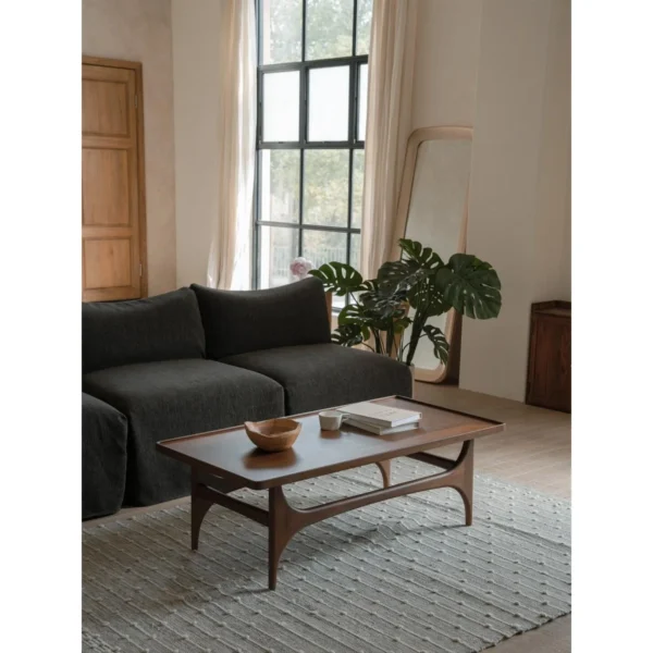 Capu Teak Coffee Table with Sculpted Legs and Framed Top in walnut — in a room setting