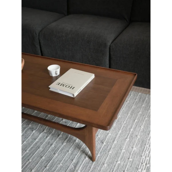 Capu Teak Coffee Table with Sculpted Legs and Framed Top in walnut — in a room setting