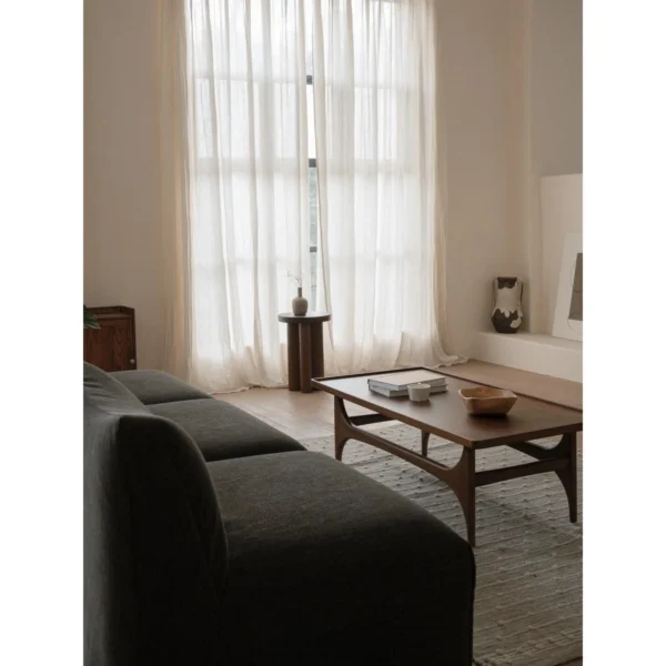 Capu Teak Coffee Table with Sculpted Legs and Framed Top in walnut — in a room setting