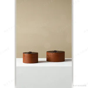 Caramel Leather Round Storage Box with Lid in clay — in a room setting