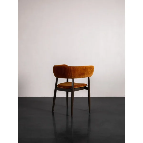 Caramel Velvet Curved-Back Dining Chair on Slim Dark Legs in rust — in a room setting