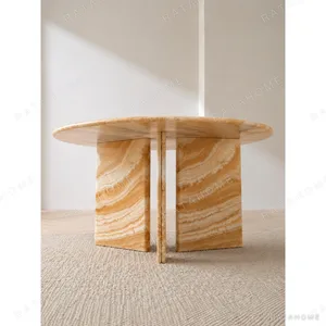 Caramel Onyx Round Dining Table on Curved Stone Legs in rust — in a room setting