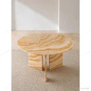 Caramel Onyx Round Dining Table on Curved Stone Legs in rust — in a room setting