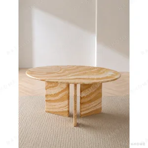 Caramel Onyx Round Dining Table on Curved Stone Legs in rust — in a room setting