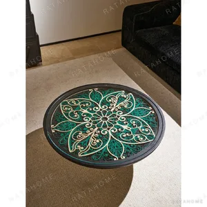 Carved Blue and White Floral Round Coffee Table in blue — in a room setting