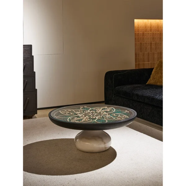 Carved Blue and White Floral Round Coffee Table in blue — in a room setting